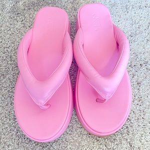 Pink thong platform sandals.
